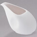 A white porcelain creamer with a curved edge and white center.