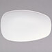 A warm white porcelain coupe platter with a small oval shape on it.