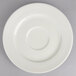 A warm white porcelain saucer with a circular rim.