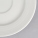 A warm white porcelain saucer with a thin white rim.