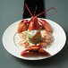 A lobster and garnished shrimp in a Oneida Manhattan porcelain rim soup bowl.