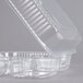A close-up of a Durable Packaging clear hinged lid plastic container with three compartments.