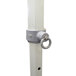 A white pole with a metal ring on top.