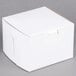 A 5 1/2" x 5 1/2" white bakery box with a lid.