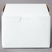 A 5 1/2" x 5 1/2" white bakery box with a brown lid.