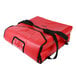 A red insulated vinyl pizza carrier with black straps and a zipper.