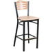 A Lancaster Table & Seating black bistro bar stool with a natural wood seat.