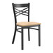 A Lancaster Table & Seating black metal chair with a natural wood seat.