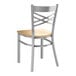 A Lancaster Table & Seating metal chair with a wooden seat and wood back.