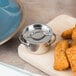 A silver American Metalcraft mini pot with a lid filled with fried chicken nuggets on a table.