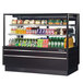 A Turbo Air black refrigerated bakery display case with drinks and snacks on display.