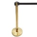 A close-up of a gold Lancaster Table & Seating crowd control stanchion pole.