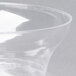 A clear plastic Fineline Savvi Serve bowl on a white surface.