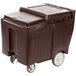 A dark brown plastic container with sliding lid and wheels.