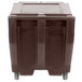 A dark brown Cambro mobile ice bin with sliding lid and wheels.