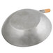 A Town hand hammered wok with a wooden handle.