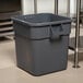 A Continental 32 gallon grey plastic bin in a school kitchen.