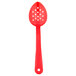 A red plastic Thunder Group salad spoon with holes.