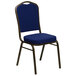 A navy blue banquet chair with a gold metal frame.