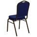 A blue banquet chair with a gold metal frame.