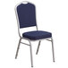 A Flash Furniture navy blue fabric banquet chair with a silver frame and crown back.
