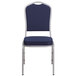 A Flash Furniture navy blue fabric banquet chair with a silver frame.