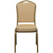 A Flash Furniture beige banquet chair with gold frame and cushion.