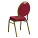 A burgundy Flash Furniture banquet chair with a gold frame.