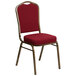 A burgundy Flash Furniture banquet chair with a gold metal frame.