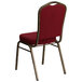 A burgundy Flash Furniture banquet chair with a gold vein metal frame.
