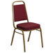 A burgundy Flash Furniture banquet chair with a gold metal frame.