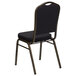 A black banquet chair with gold dots on the backrest.