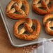 A tray of Dutch Country Foods gluten-free soft pretzels on a table.