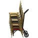 A stack of chairs stacked on a Flash Furniture stacking chair dolly with wheels.