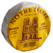 A round yellow and white Notre Dame Baby Brie cheese wrapper.