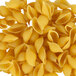 A pile of Barilla medium shell-shaped pasta on a white background.