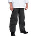 A person wearing black and white striped Chef Revival chef pants.
