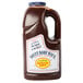 A gallon bottle of Sweet Baby Ray's barbecue sauce with a label.