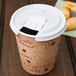 A brown paper coffee cup with a Solo white tear tab lid.