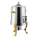 A stainless steel coffee chafer urn with gold accents.