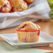 A Bake'n Joy cranberry orange nut muffin on a plate.