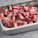 A tray of Warrington Farm Meats Beef Stew cubes on a counter.