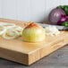 A Jumbo Sweet Onion on a cutting board.