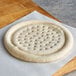A Rich's par-baked pizza crust on a cutting board.