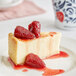 A slice of cheesecake with Fabbri Wild Strawberries on top.