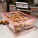 A red Cambro lid on a food storage box with potatoes in it.