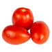 A group of plum tomatoes on a white background.