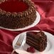 A Pellman raspberry chocolate cake on a plate with a fork.