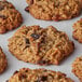 A Hope's Cookies gourmet oatmeal cranberry cookie baked on a white surface.