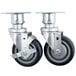 Two Vulcan metal casters with black rubber wheels.
